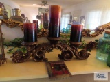 Heavy candelabra with candles and wall hanging