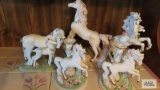 Lot of porcelain gallery unicorn figurines. One...has a broken horn