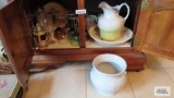 Lot of colored stemware, straw dispenser, spongeware pie plate, stein, and etc in bottom of cabinet
