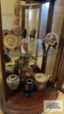 Lot of Oriental figurines, plates, metal vase, teapot and etc in bottom of cabinet