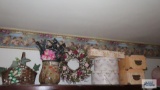 Lot of decorative boxes, vase, basket and wreath on top of headboard