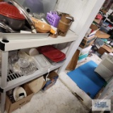 Copper cup, glass baking dishes, state quarters lunch box, pizza stone, and etc on shelf