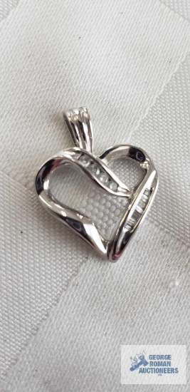 Silver colored heart-shaped pendant with clear gemstones, marked 10K, 2.0 G