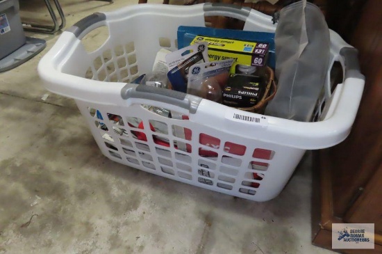 Basket full of miscellaneous, including light bulbs. Lock and keys.