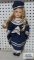 Porcelain face doll with navy dress, has crack under hair