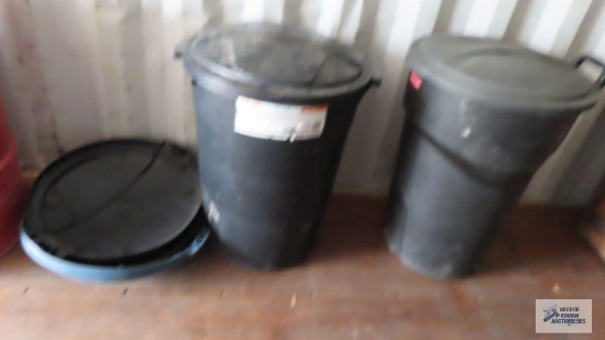 two Rubbermaid trash cans with lids