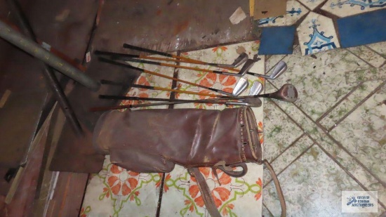 Antique leather golf bag with clubs