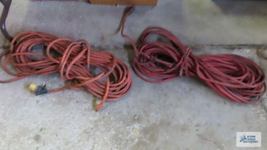 Two heavy duty extension cords. One needs repaired.