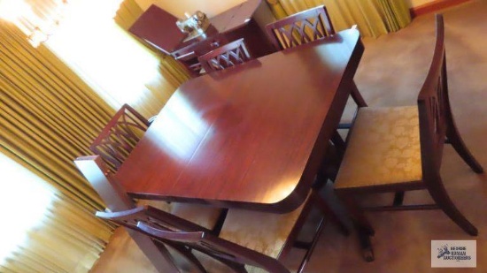 Vintage mahogany dining room table with six chairs and two extra leaves