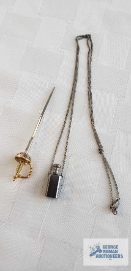 Decorative sword stick pin, marked Toledo. Small perfume bottle on chain.