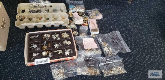 Large variety of single earrings, pins, brooches, sweater clips, most missing stones