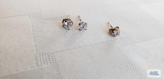 Pair of clear gemstone earrings, marked 10K. One single clear gemstone earring, marked 14K.