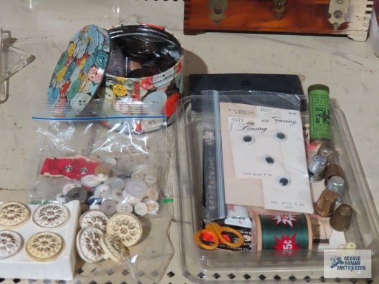 lot of buttons, thimbles and sewing supplies