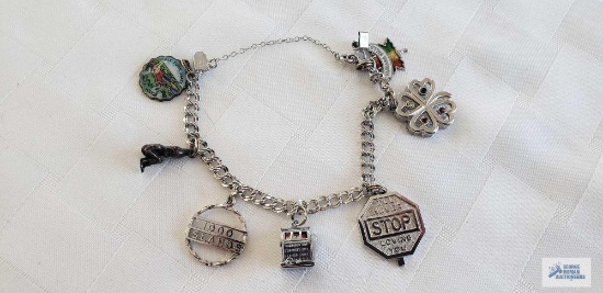 Silver colored charm bracelet, marked Alcoa Sterling with seven charms, two...are marked Sterling