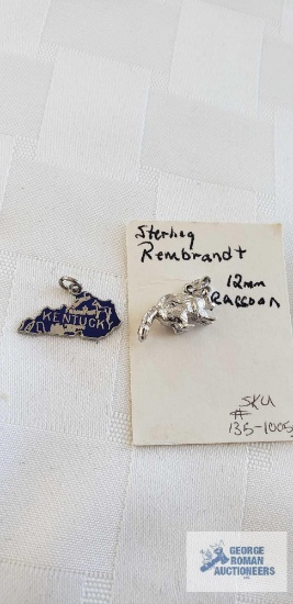 Kentucky and raccoon pendants, both marked Sterling