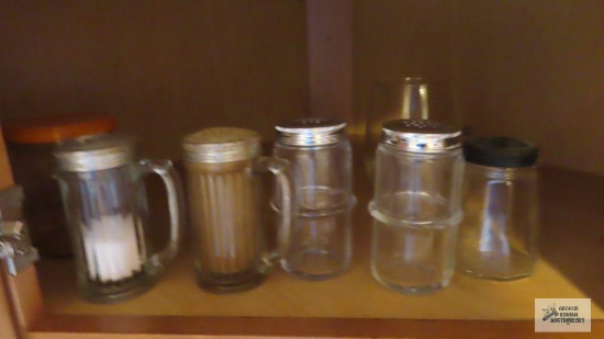 Shelf of assorted vintage shakers