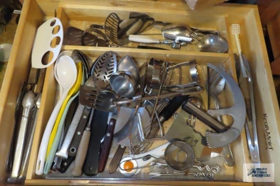 Drawer...full of assorted...spoons,...tongs and other utensils