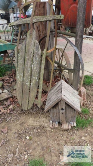 Antique sled, wagon wheel, and birdhouse