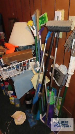 lot of brooms, mops, dustpan and etc