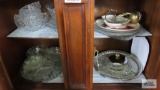 large assortment of glassware, decorative plates, and lazy Susan
