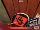lot of crime watch signs, orange flags and slow / stop signs