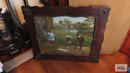 Children burying bunny print in decorative vintage wooden frame