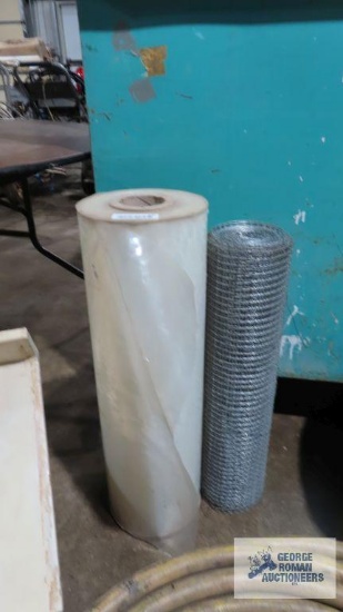 Plastic sheeting and roll of wire fencing