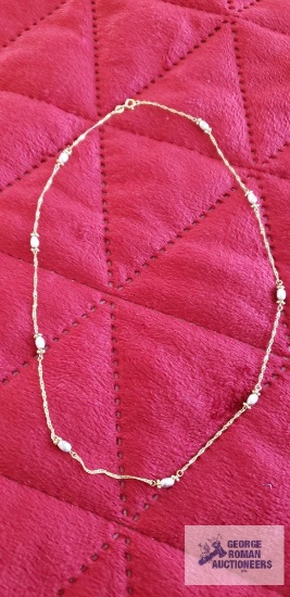 Gold colored chain with pearl like beads, marked 14K, total approximately is 2.72 G