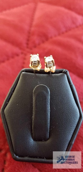 Two gold colored and clear gemstone earrings, marked 10K, backs are also marked 10K, total