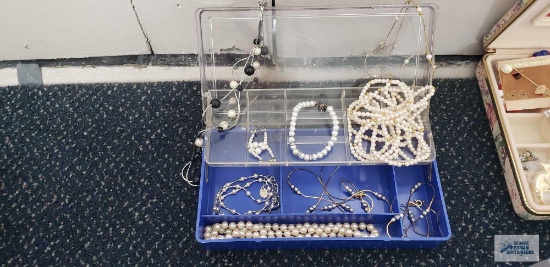 Pearl like costume jewelry in clear plastic divided container