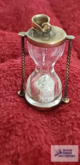 Gold colored and glass hourglass pendant, marked 10K, approximate total weight 2.59 G