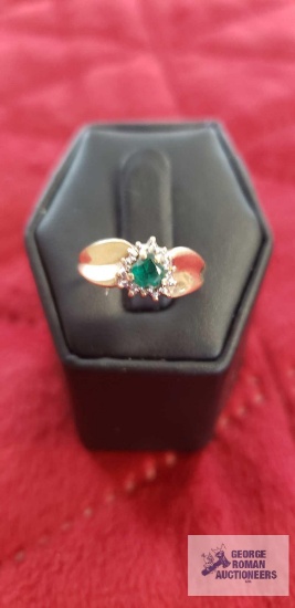 Gold colored ring with green gemstone and clear gemstone chips, marked 10K, approximate total weight