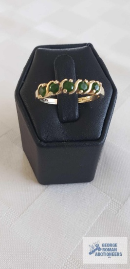 Gold colored ring with five green gemstones, marked 14K, total weight approximately 2.98 G