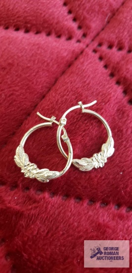 Gold colored floral hoop earrings, marked 10K, approximate total weight is 1.15 G