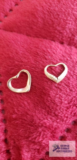 Two small gold colored heart-shaped pendants, both Marked 14K, total approximately is .66 G
