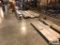 ALUMINUM SHEETS AND STEEL PIECES ON FLOOR AND ALONG THE WALL. RACK AND CONTENTS ON RACK NOT