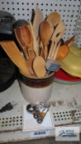 Ivory and brown crock with wood and metal utensils