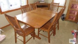 Heavy wood dining room table with three leaves and six chairs