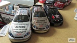 Three diecast Dale Earnhardt cars.
