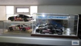 Three diecast Dale Earnhardt and Dale Earnhardt Jr. cars, two are in plastic case.