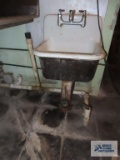 Vintage cast iron hand sink with faucet. Bring tools for removal.