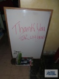 Dry erase board with markers, calculators, etc.