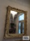 Ornate gold framed beveled wall mirror. 51