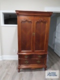 Cherry finish entertainment cabinet by Lexington Furniture Industries. In walk out basement. 39