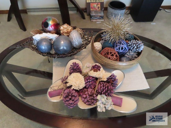 variety of decorations including plastic bowl, ceramic centerpiece dish, and decorative fruit basket