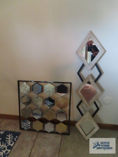 Two decorative mirrored wall hangings