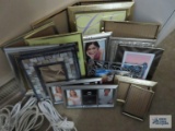 Variety of silver and gold colored picture frames.