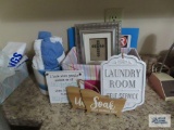 Laundry room self-service sign, towels, religious wall hanging, etc