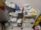 Two rolling metal storage racks including hand towels, washcloths