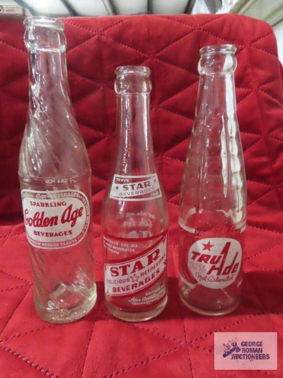 Three bottles including Golden Age, Star Beverages, and Tru Ade